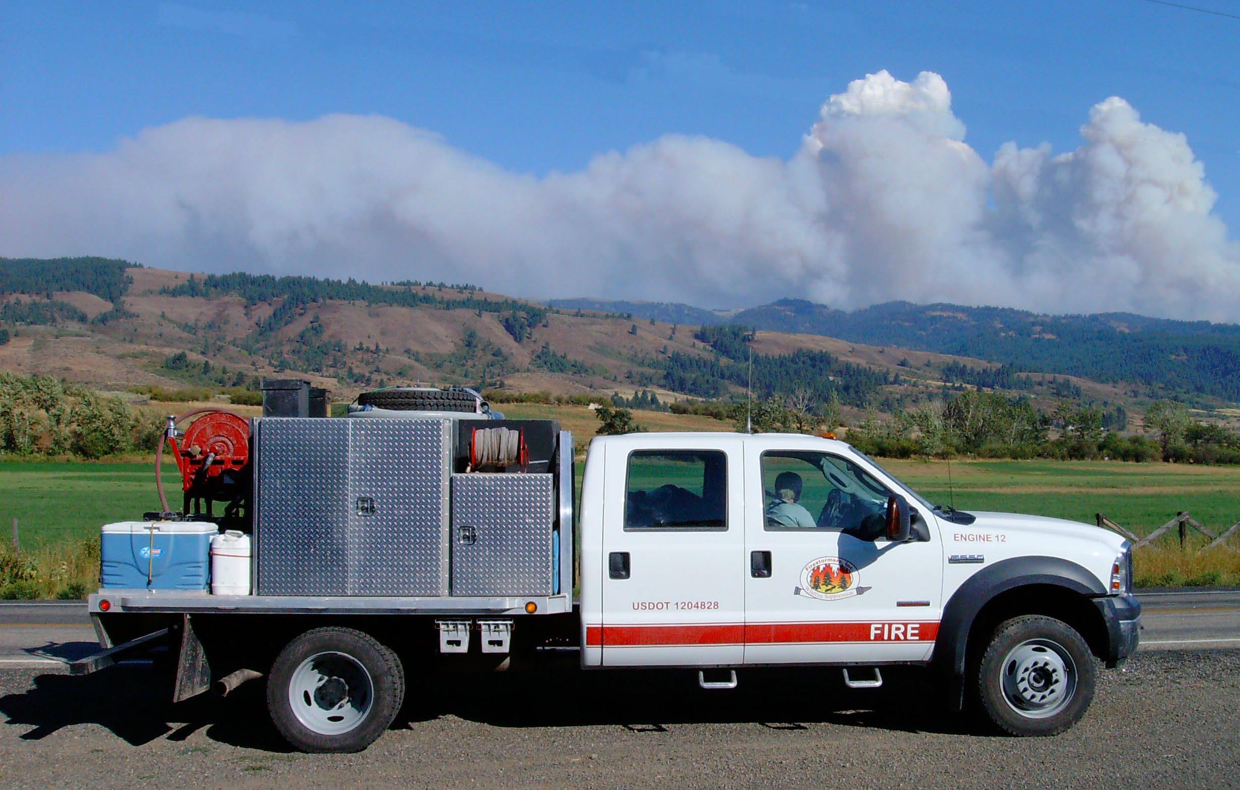 Fire crew stopped in Idaha for a photo opportunity with a large fire Defensive Eco- __fg_link_0__  courses both reduce incidents and improve fuel efficiency. in the background.